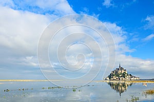 Mont Saint Michel abbey on the island with reflection in water, Normandy, Northern France, Europe