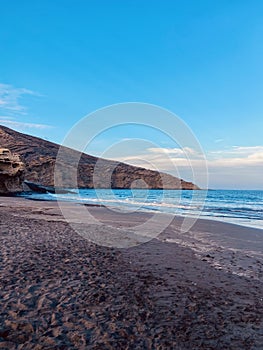 MontaÃ±a Pelada beach in the evening without people, blue ocean and volcanic mountain, peaceful moment photo