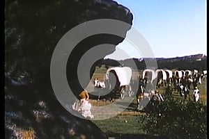 Montage of covered wagons and settlers traveling cross country