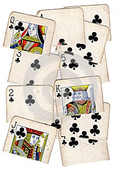A montage of torn halves of vintage playing cards featuring clubs.