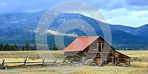 Montana panorama of ranch cabin in pasture.