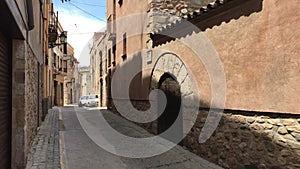 Montblanc, Spain, A stone building that has a sign on a brick sidewalk