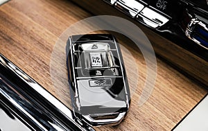 The new Rolls Royce Cullinan wireless keys in white perforated leather interior with natural wood panel. Rolls-Royce Cullinan luxu