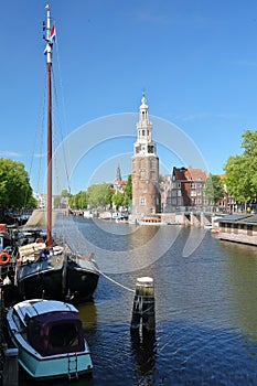 Montelbaanstoren Tower built in 1516, viewed through Oudeshans canal in Amsterdam Centrum