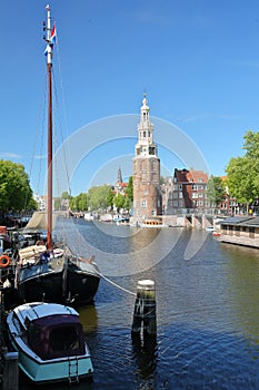 Montelbaanstoren Tower built in 1516, viewed through Oudeshans canal in Amsterdam Centrum photo