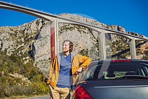 Montenegro. Man in the background of Bridge Moracica. Reinforced concrete bridge across the Moraci gorge. The motorway