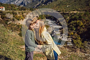 Montenegro. Mom and son tourists on the background of Clean clear turquoise water of river Moraca in green moraca canyon