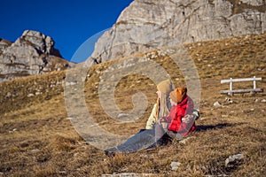 Montenegro. Mom and son tourists in the background of Durmitor National Park. Saddle Pass. Alpine meadows. Mountain