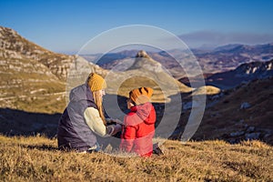 Montenegro. Mom and son tourists in the background of Durmitor National Park. Saddle Pass. Alpine meadows. Mountain