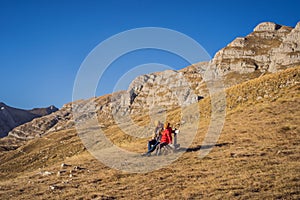 Montenegro. Mom and son tourists in the background of Durmitor National Park. Saddle Pass. Alpine meadows. Mountain