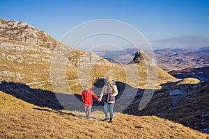 Montenegro. Mom and son tourists in the background of Durmitor National Park. Saddle Pass. Alpine meadows. Mountain