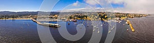 The Monterey Bay Aquarium with many yachts docked by the coastline in Monterey, California