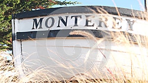 Monterey sign on boat stern, fisherman vessel near Cannery Row and Bay Aquarium.