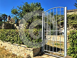 Monterubbiano town, Fermo province, Marche region, Italy. Gate, olive tree and secret corner