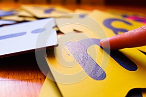 Montessori letter cards, finger swipe texture, enhances dyslexic children`s learning photo