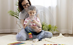 Montessori material. Child toddler learns geometric shapes from wood