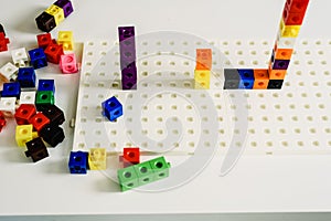 Montessori material, game to learn addition, made in colorful plastic blocks, inside a Montessori classroom