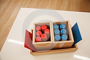 Montessori material noisy cylinders in classroom.