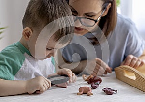 Montessori material. Schoolboy plays doctor at home