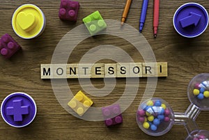 Montessori on wooden alphabet concept with toys on wooden background