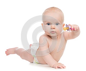 6 month child girl lying happy holding baby nipple soother photo