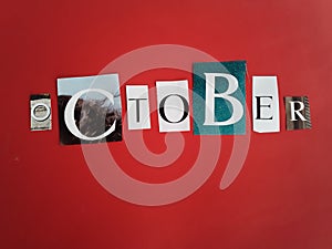 Month of October word on scraps of magazine clippings on a red background