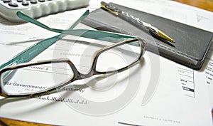 Monthly bills with glasses and checkbook