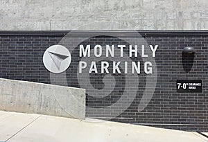 Monthly Parking Sign Outside a Garage Ramp