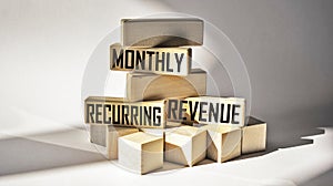 Monthly Recurring Income MRR text on wood blocks.