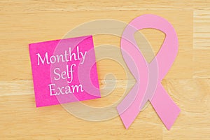 Monthly self exam reminder with pink cancer ribbon