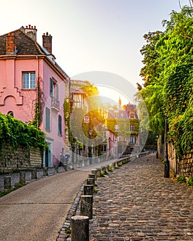 Montmartre district of Paris. Houses on narrow road in Montmartre district of Paris. View of cozy street in quarter Montmartre in