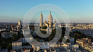 Montmartre hill with Basilique du Sacre-Coeur in Paris at sunset