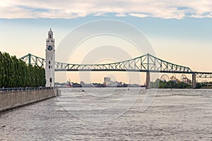 Montreal Clock Tower and Jacques Cartier Bridge at sunset in Summer