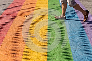 Man walking on gay rainbow crosswalk in Montreal gay village