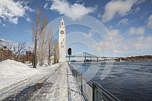 Montreal Clock Tower on a cloudy sky in the Old Port besie the St-Lawrence seaway