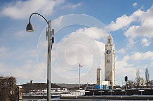 The Montreal Clock Tower with a street lamp in the Old Port in the winter 2022