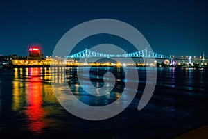 Montreal\'s Jacques Cartier Bridge illuminated with blue lights at night