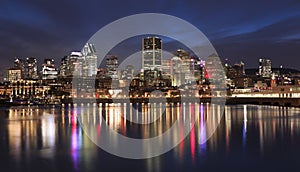 Montreal skyline illuminated at night with nice reflections in Saint Lawrence River