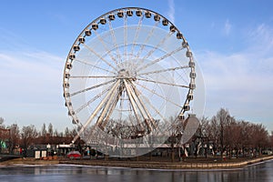 Montreal tourism - ferris wheel, details, on blue sky background. Amusement park, festive mood. viewpoint