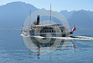 Montreux Switzerland - October 12 2017: Excursion ship and people in the pier on Geneva Lake in Montreux Swiss Riviera.