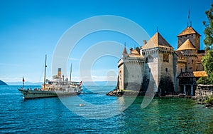 Montreux touristic steamboat on Lake Geneva and Chillon castle view with clear blue sky in Vaud Switzerland