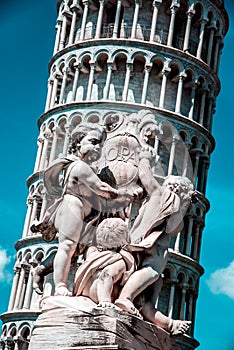 Monument on the background of the famous sloping tower with columns in Pisa, Italy. fascinating exotic amazing places