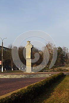 Monument on a boulevard in a small Moldavian town. Autumn landscape.