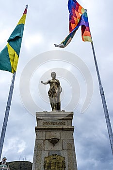 Monument with female statue and the Bolivian and Wiphala flag  in the center of Copacabana, Bolivia photo