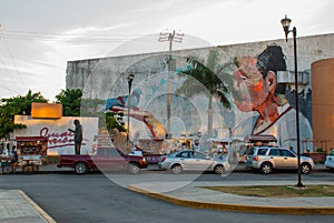 Monument and Graffiti on the wall of a building in the city Campeche, drawing a man on his hand a dove sits. San Francisco de Camp
