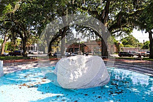 A monument with a gun, a helmet and boots at  Emmet Park on East Bay Street in Savannah, Georgia