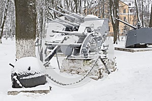 Monument with naval artillery and sea mines covered with snow