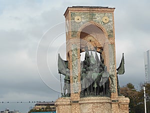 Monument of the Republic on Taksim Square in Istanbul, cloudy sky day photo