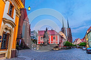 Cathedral of St. John the Baptist building with two spires in old historical city centre, evening view, Ostrow Tumski, Wroclaw