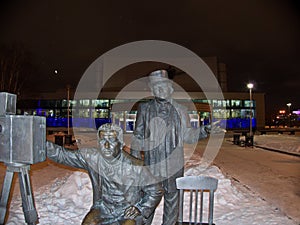 Monument to Brothers Lumiere. Night. Next to the figures of the brothers, their invention a movie camera